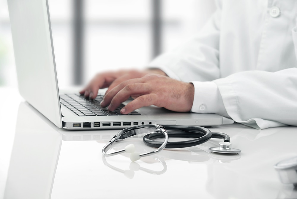 Medical professional on laptop