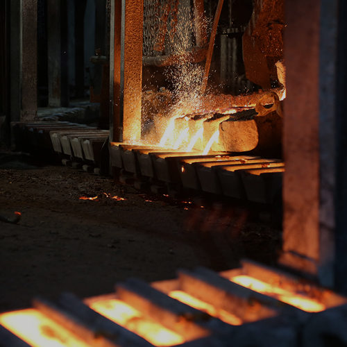 metals pouring into ingot forms