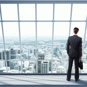 man looking on city through the window