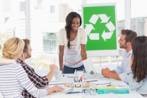 Smiling young team having a meeting about recycling policy in creative office Smiling young team having a meeting about recycling policy in creative office