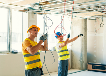 men pulling cables